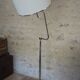 Flexible floor lamp, chrome, opaque white shade with metallic edges.