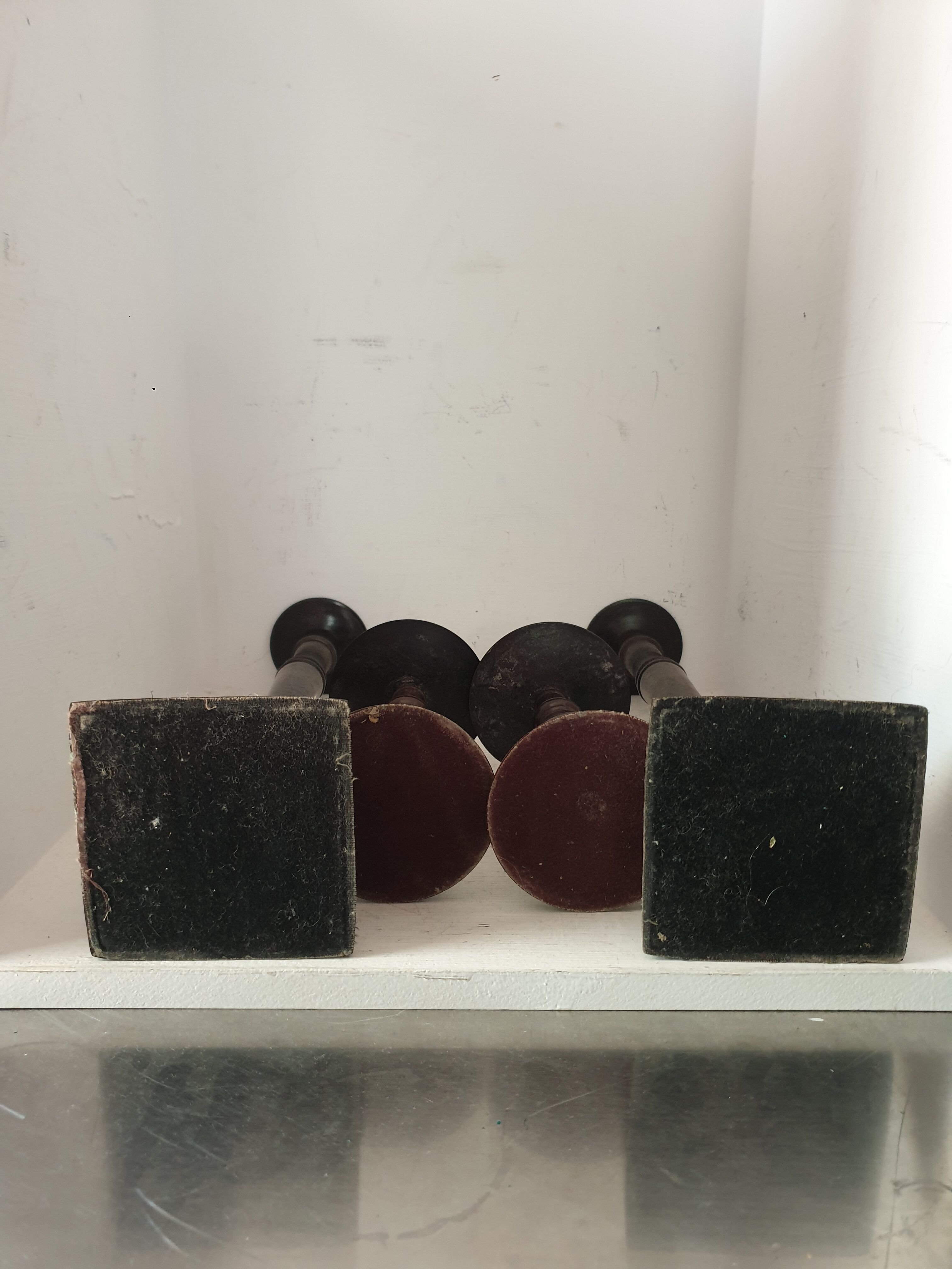 Two pairs of patinated brass candle holders