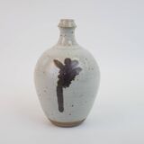 Stoneware bottle with abstract plant motif signed Herbes Folles
