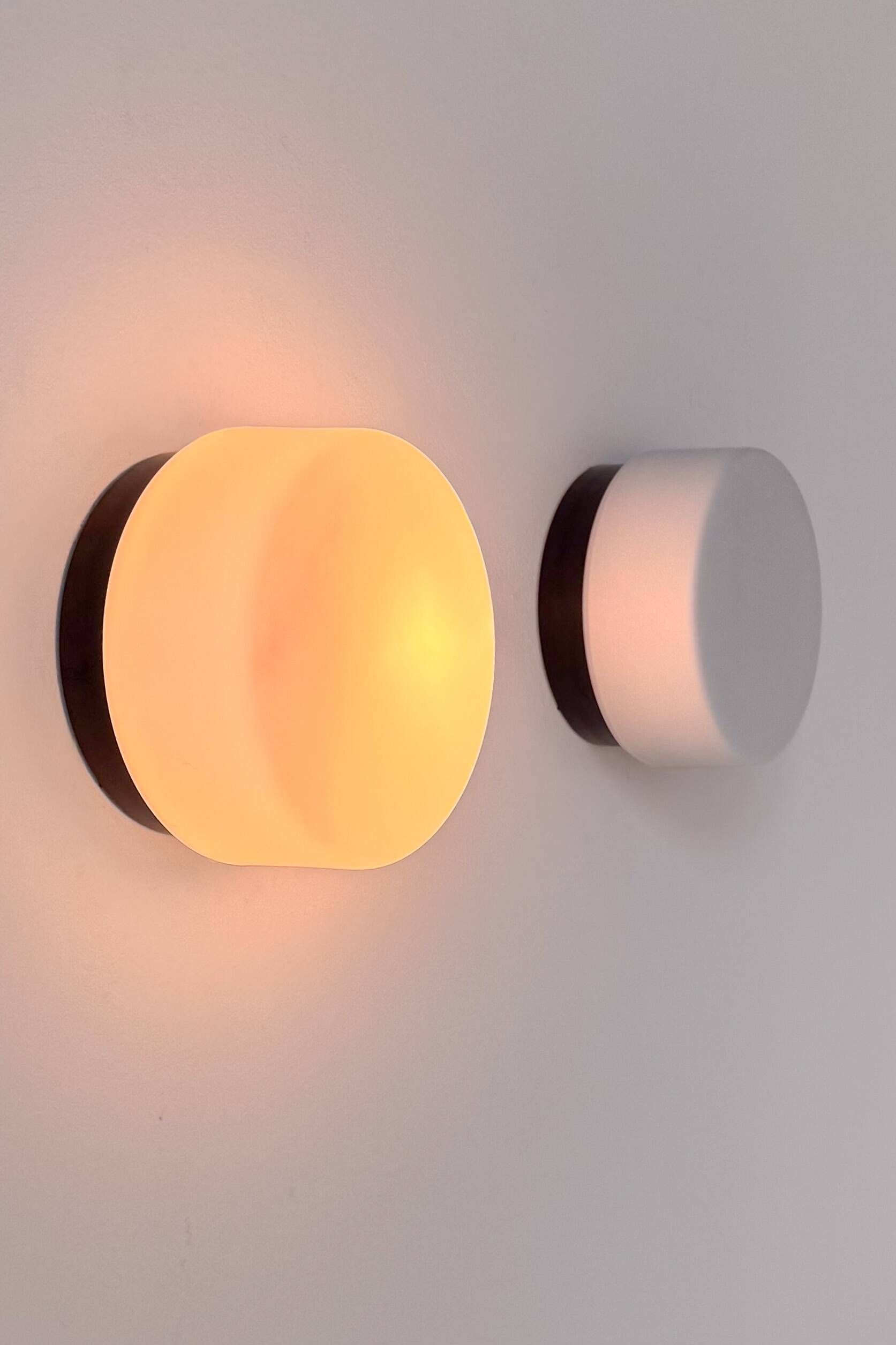 Pair of vintage wall lights in black Bakelite and frosted opal glass, France 1970.