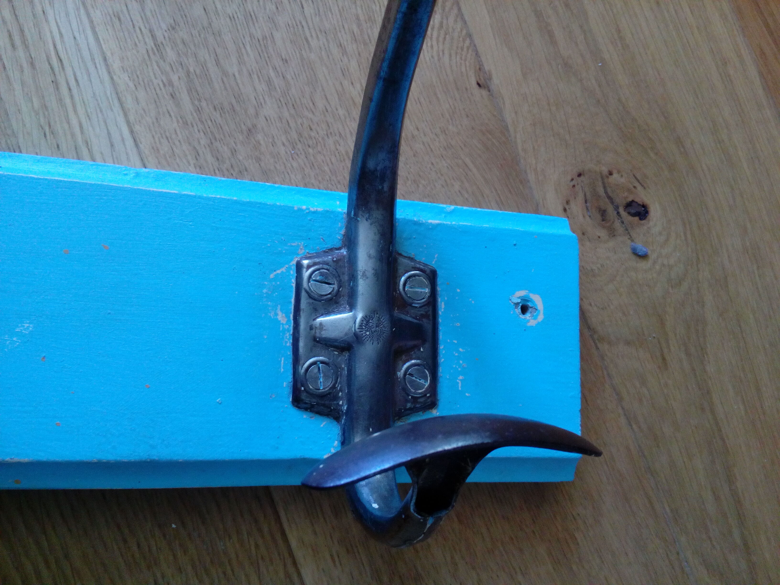 Wall coat holder with two metal pads