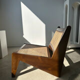 Reclined armchair in canned teak in natural wood