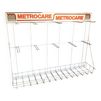 Metrocare advertising shelf in white metal, orange logo, 70s/80s