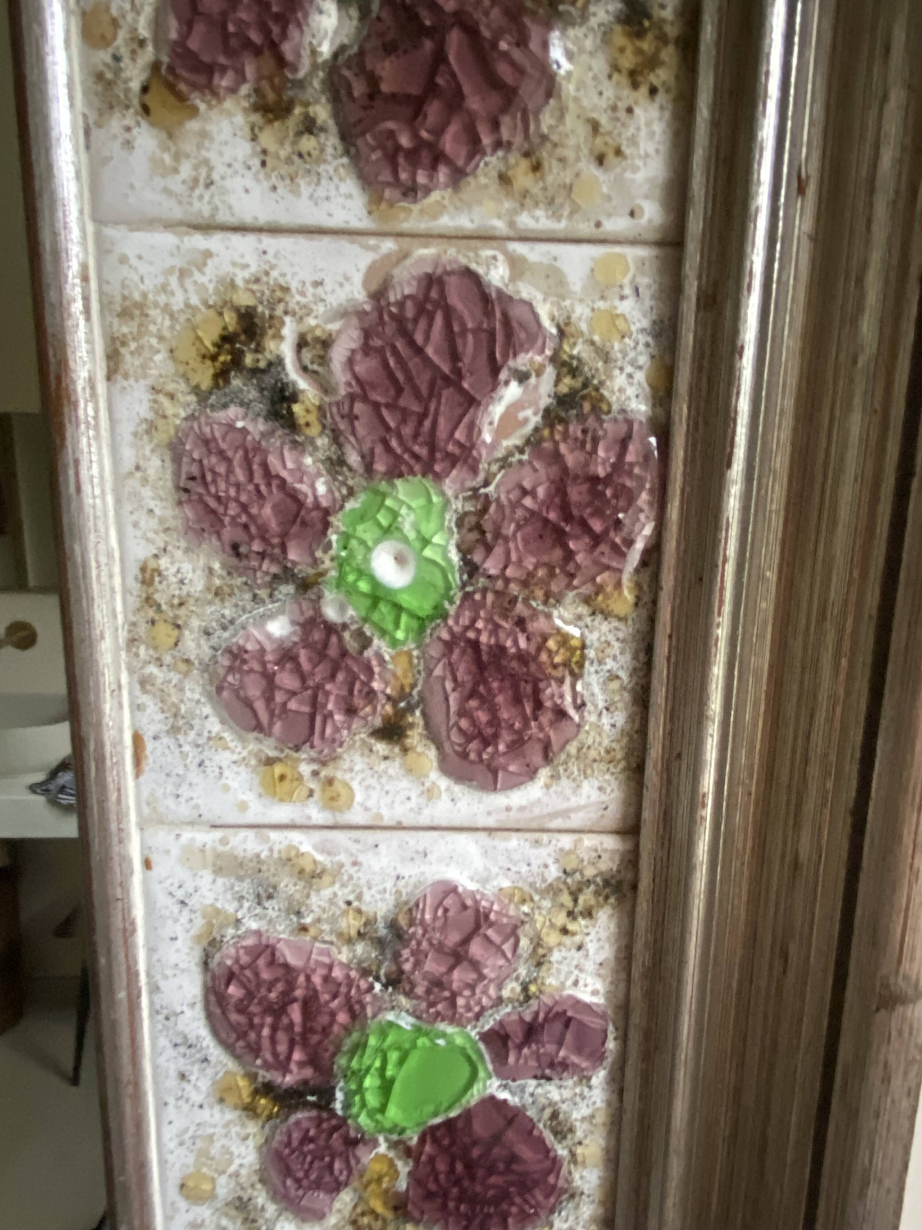 Large square ceramic mirror with floral decoration.