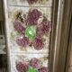 Large square ceramic mirror with floral decoration.