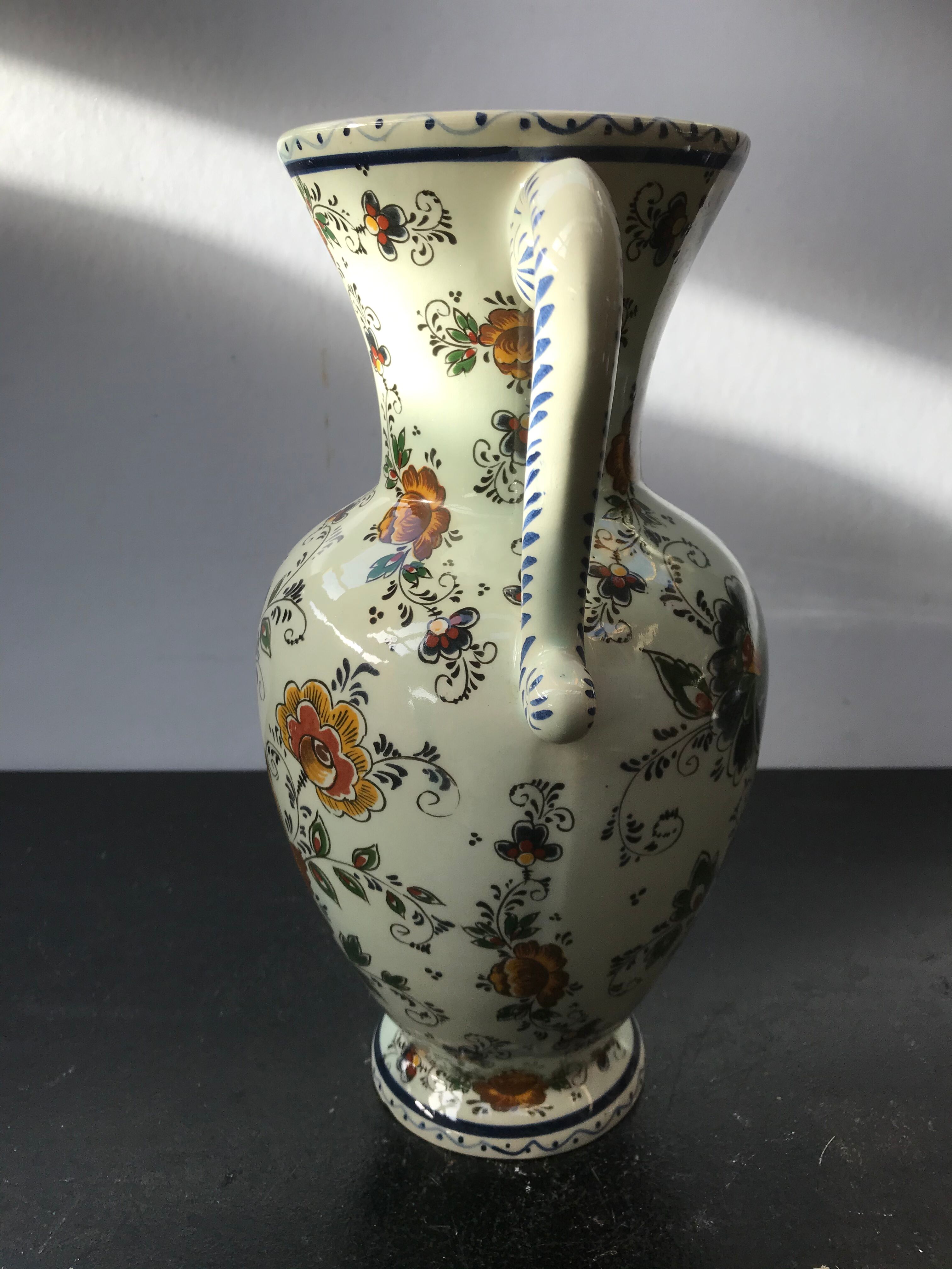 Ancient Delft vase with white ceramics decor vintage flowers