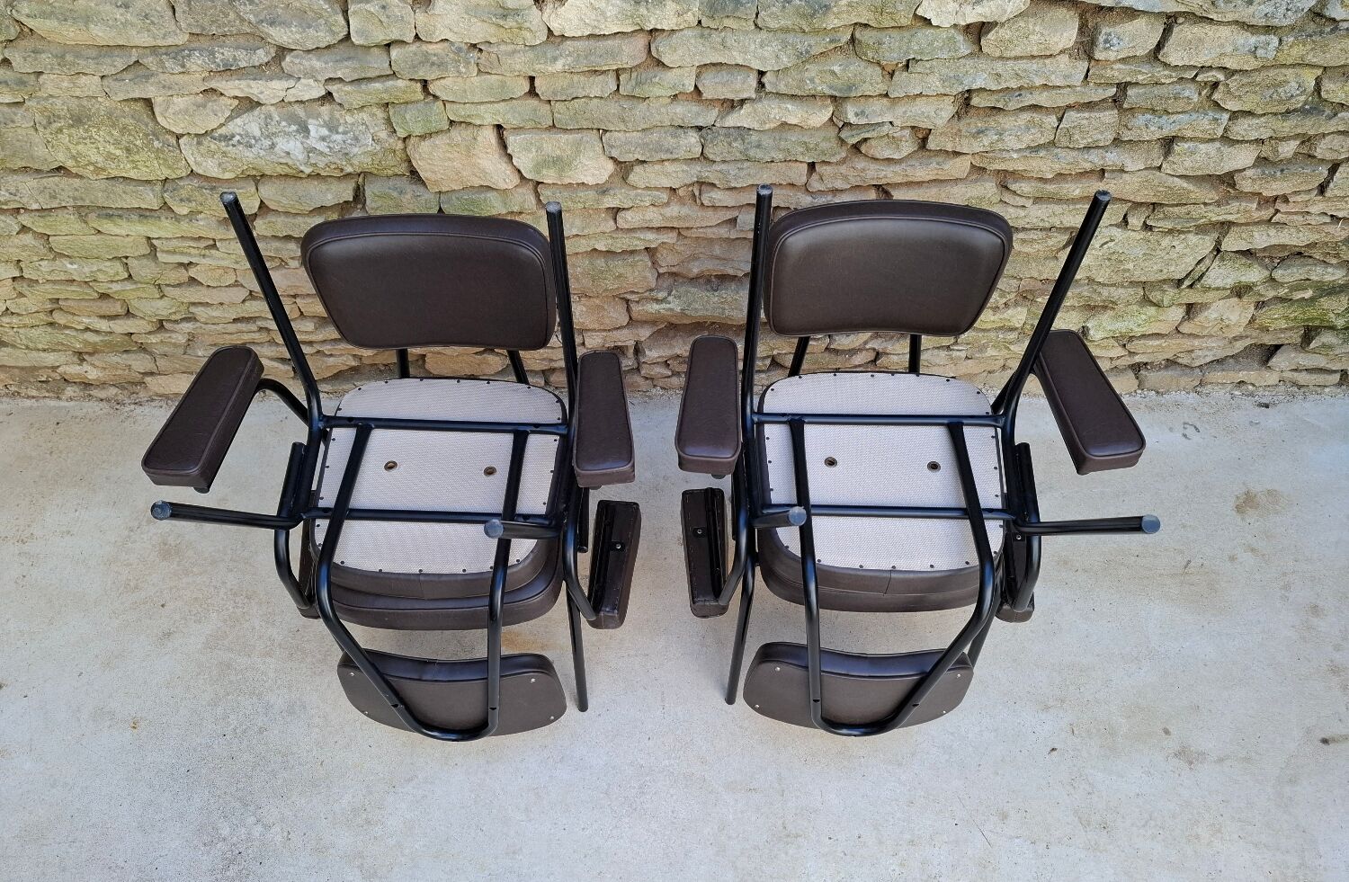 Brown faux leather armchairs