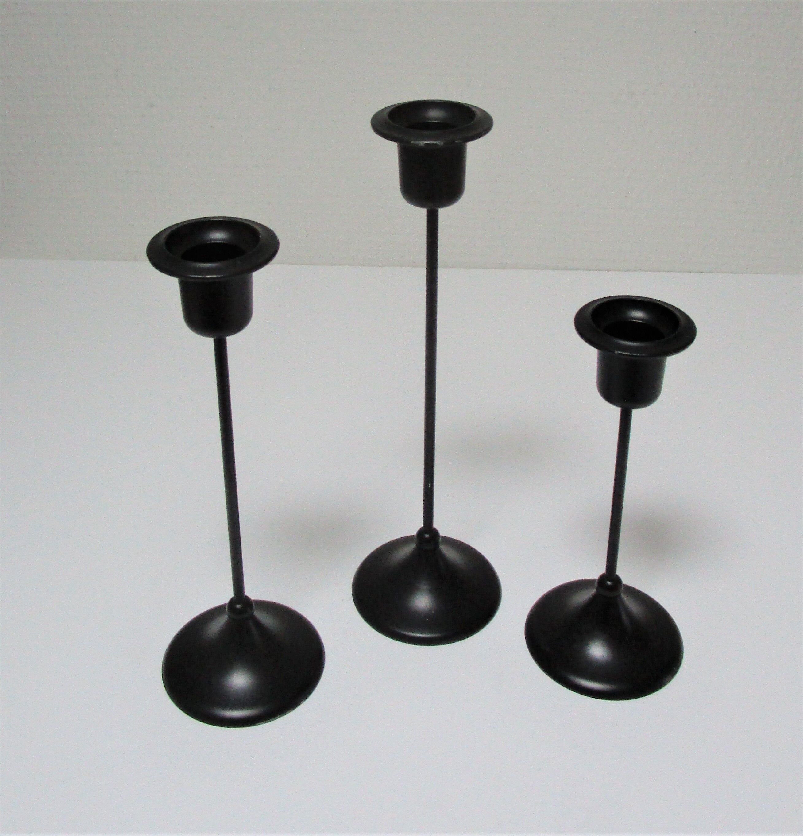 Three Scandinavian black lacquered metal candle holders