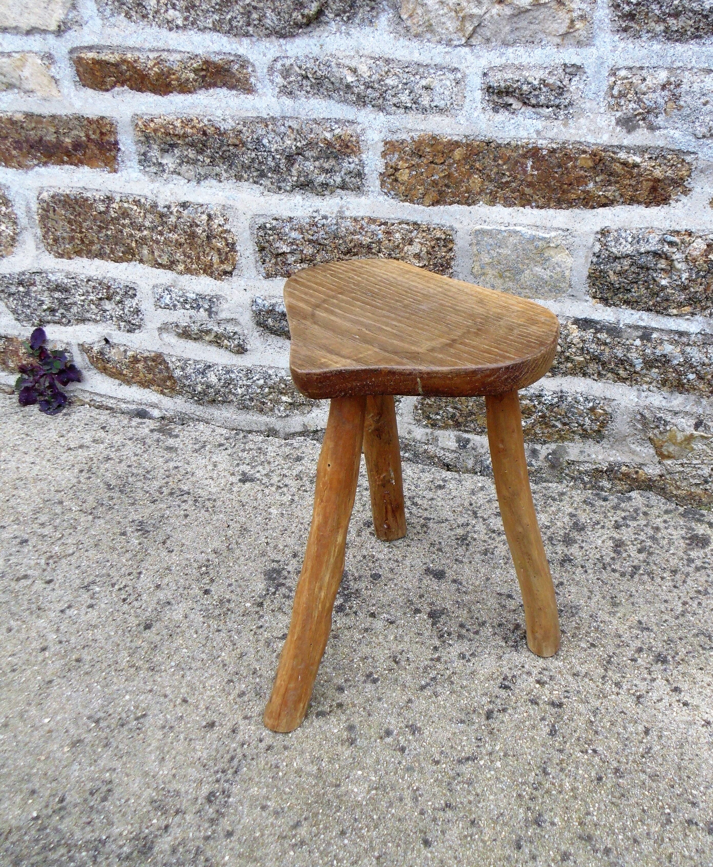 Farm stool in raw wooden sitting in the shape of a popular art