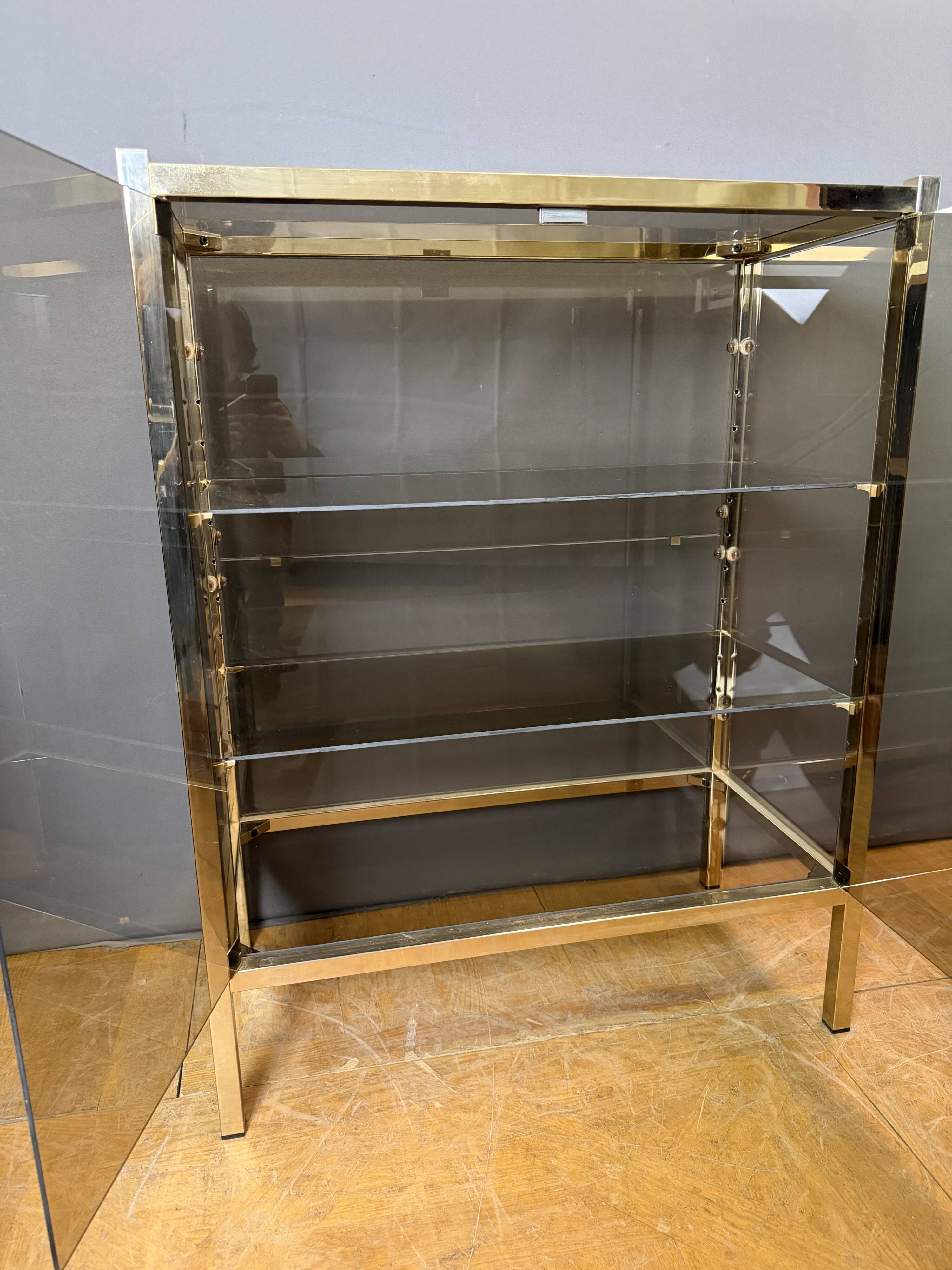 Chrome-plated brass display cabinet with smoked glass.