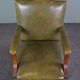 Elegant armchair and footrest in English green leather