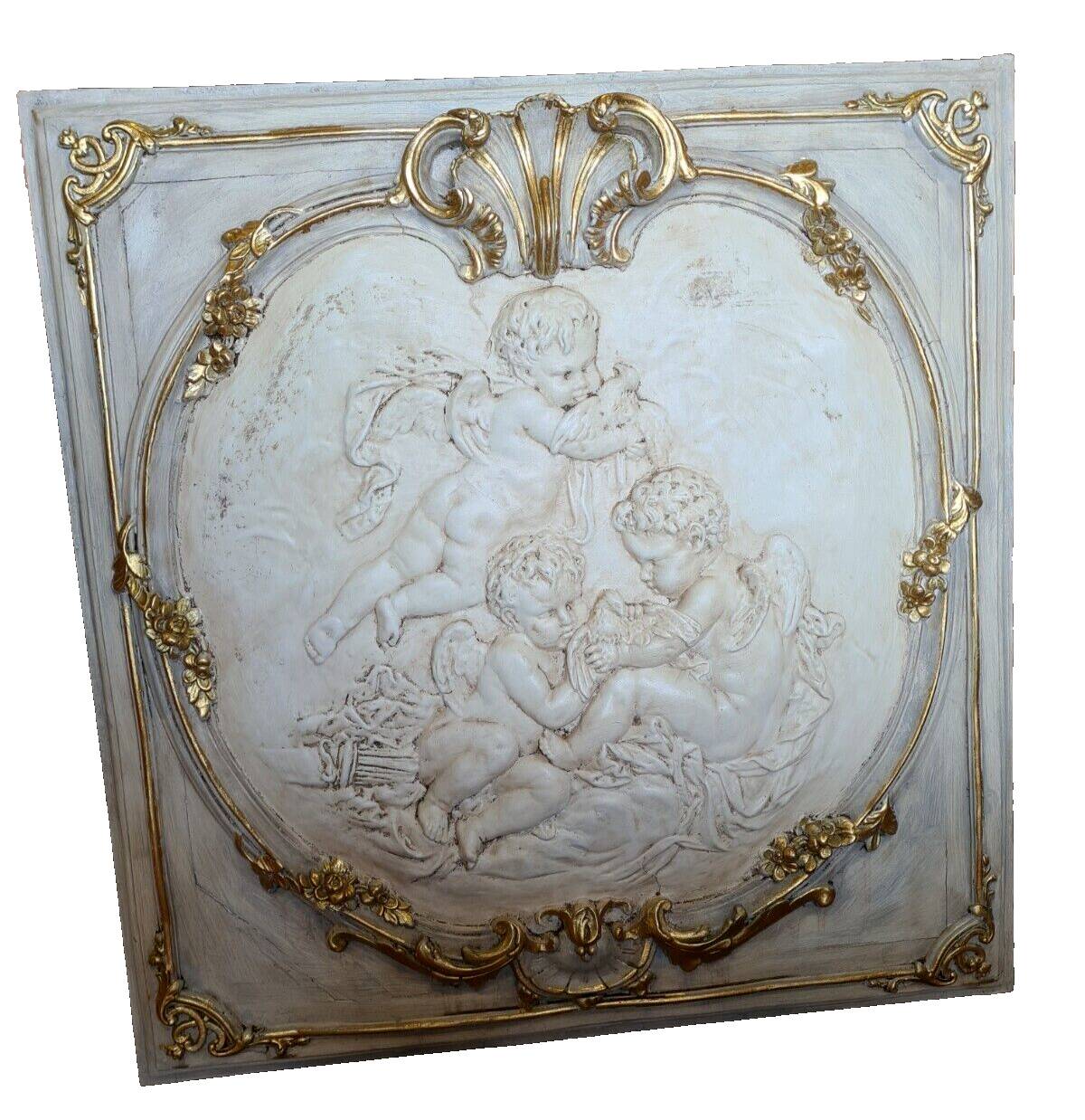 wall panel with angels in stucco and weathered wood