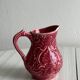 Red ceramic milk jug