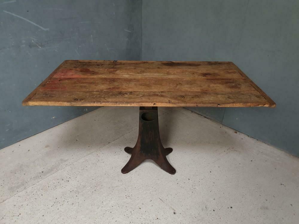 Old table on cast iron machine leg