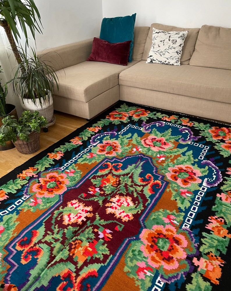 Rug with floral design on a blue background made by hand in Romania