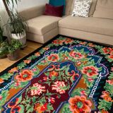 Rug with floral design on a blue background made by hand in Romania