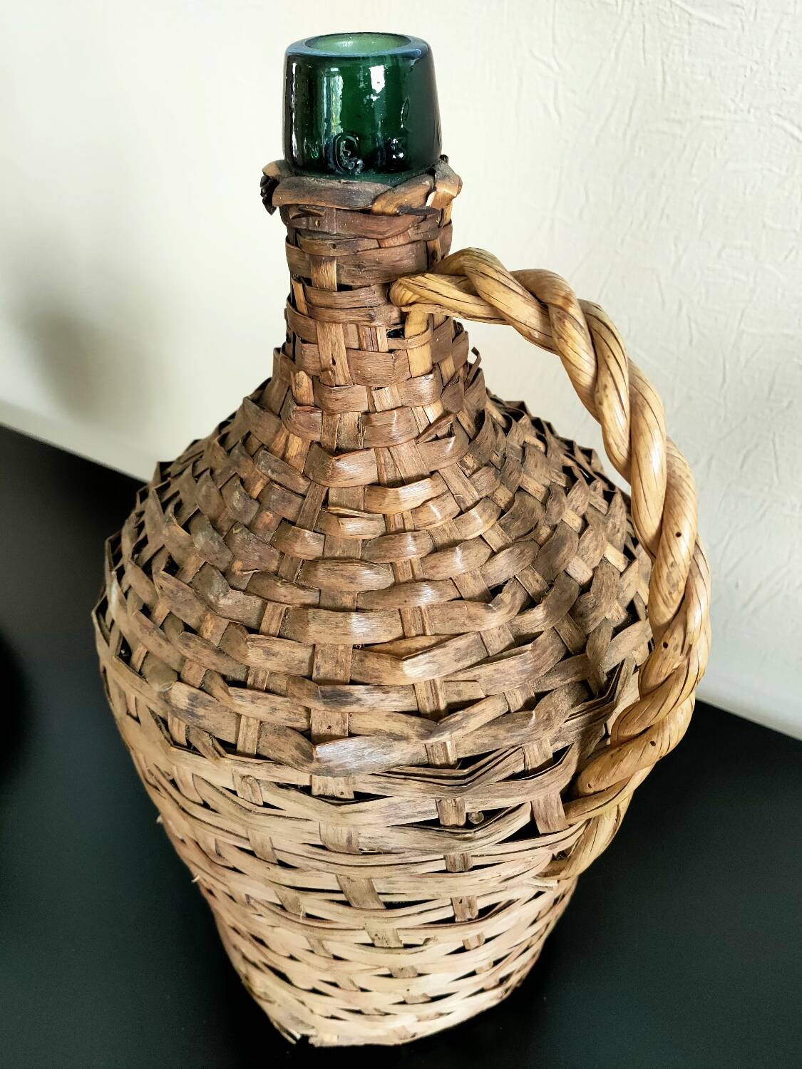 Antique demijohn made of glass and woven wicker