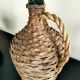 Antique demijohn made of glass and woven wicker