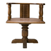 Swivel armchair in carved oak with ball bearings, early 20th century.