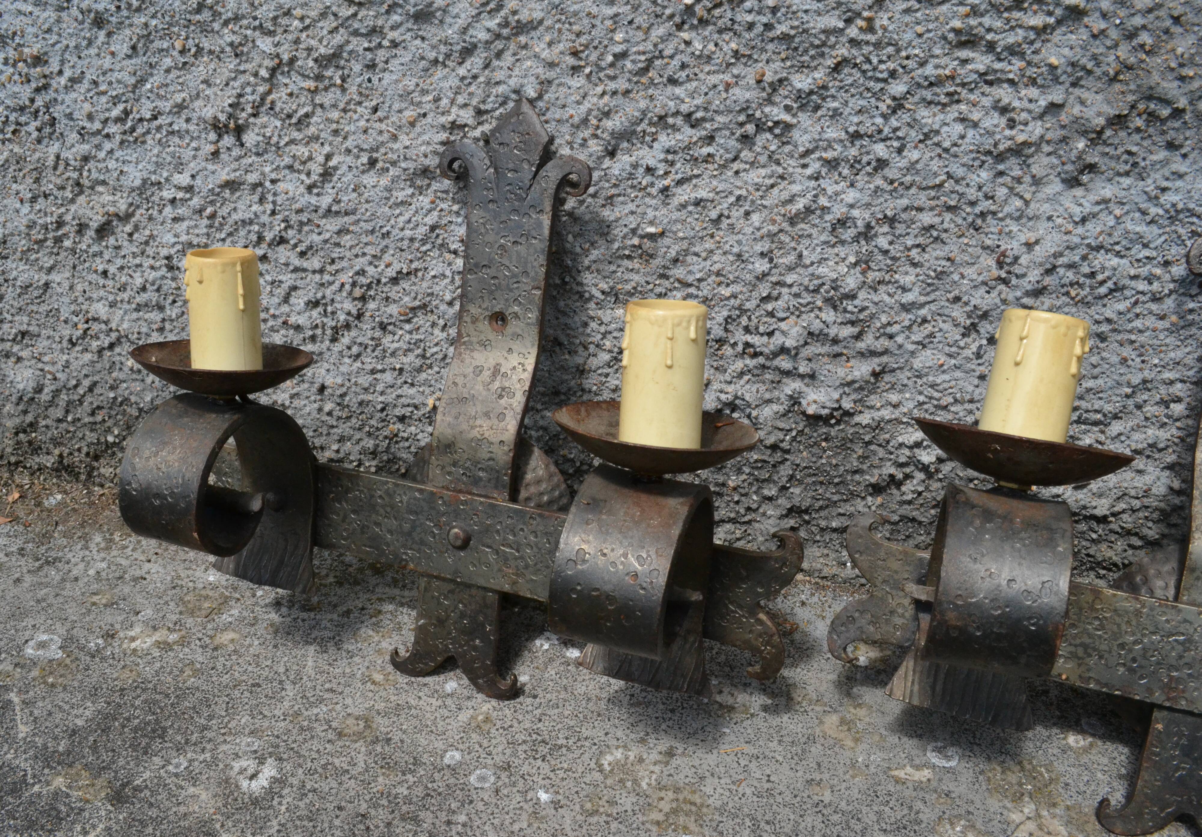 Three vintage hammered wrought iron sconces