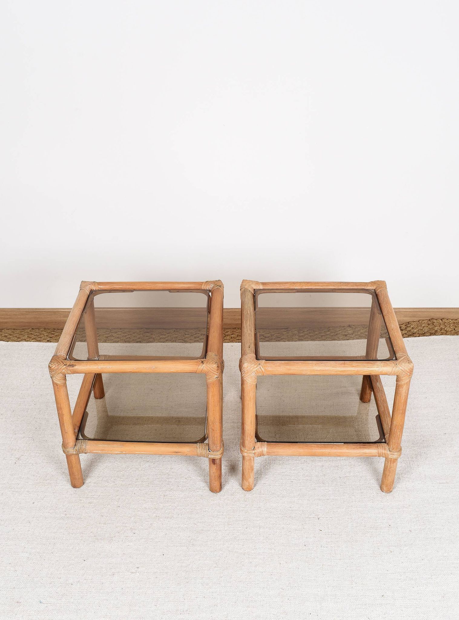 Pair of bedside tables or side tables, in rattan and smoked glass