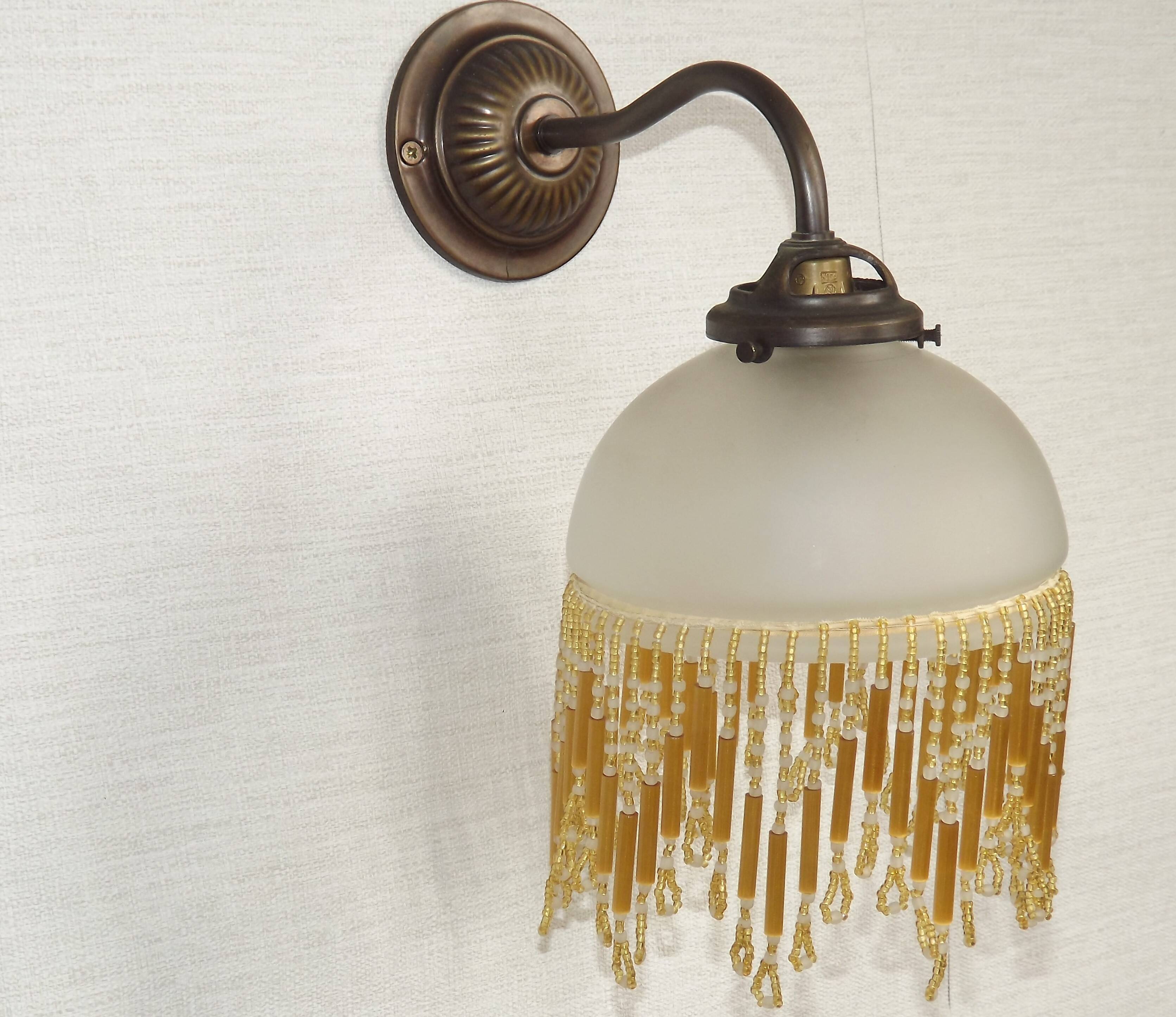 French vintage bronze effect single wall light with opaque beaded glass shade.