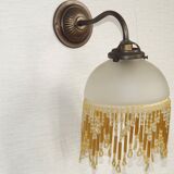 French vintage bronze effect single wall light with opaque beaded glass shade.