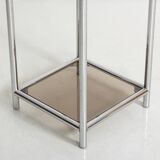 Bolster or end table in chrome steel with smoked window.