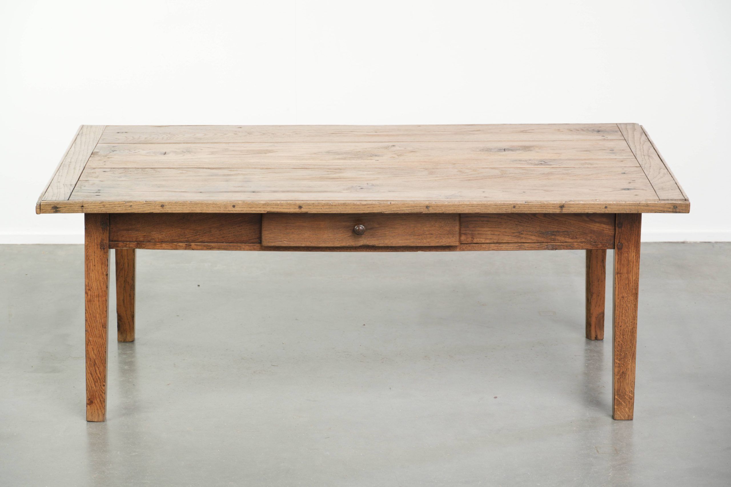 Antique pinewood coffee table with a drawer and a rural appearance