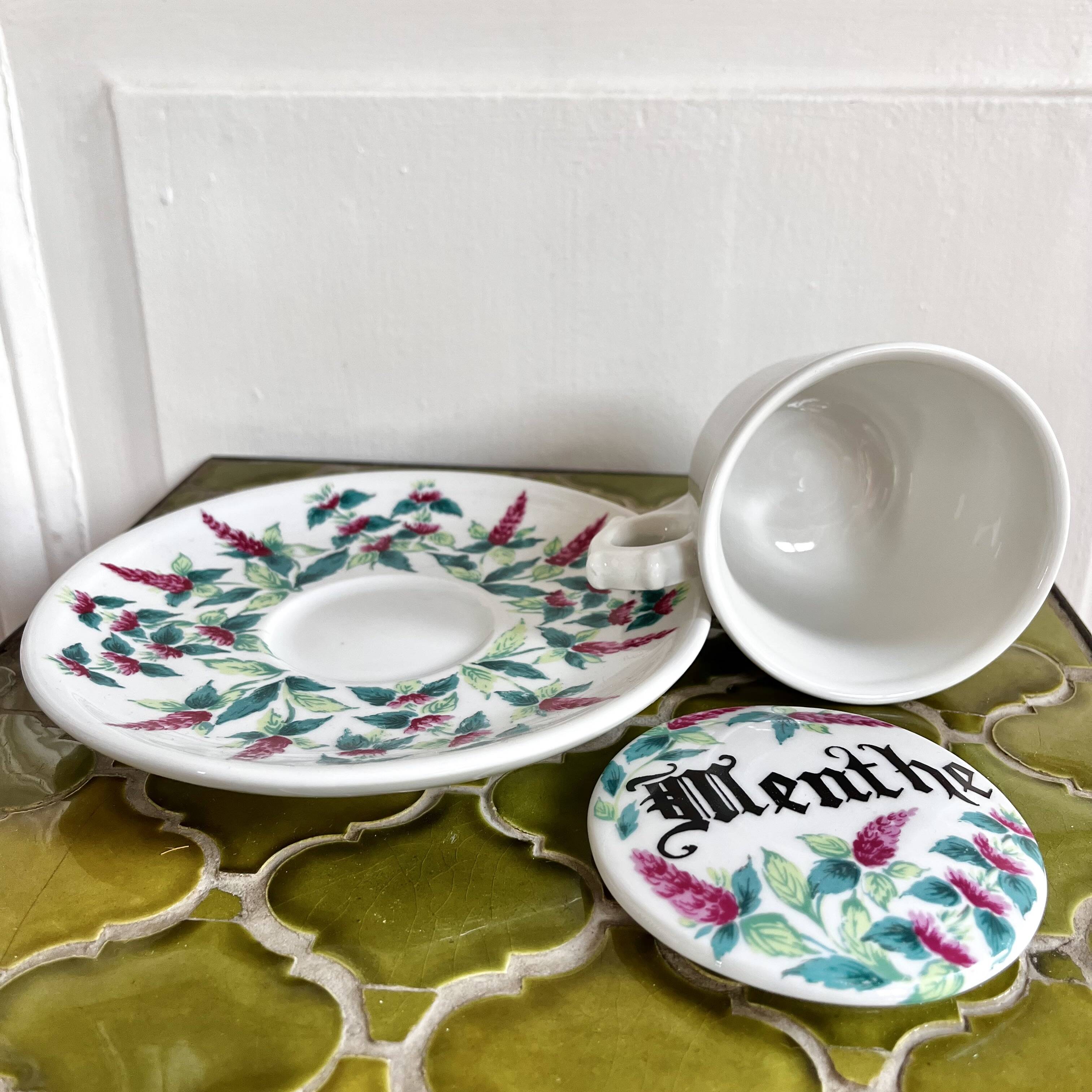 Antique herbal tea cup with mint infusion