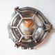 Old cast aluminum wall light with hexagonal grid and wide streaked glass.