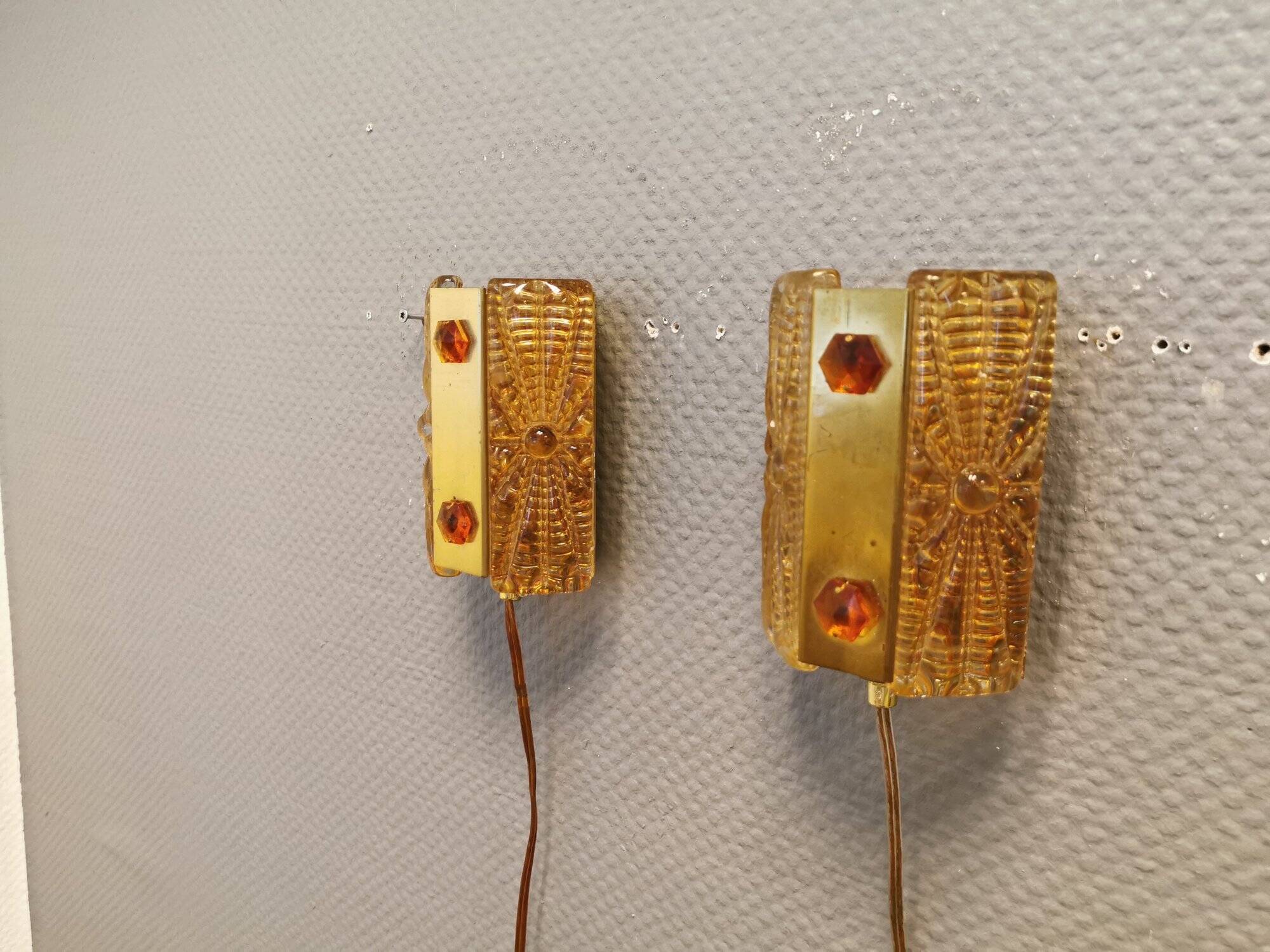 A pair of wall lights with brass-colored suspension with thick pressed glass. Vitrika, Denmark