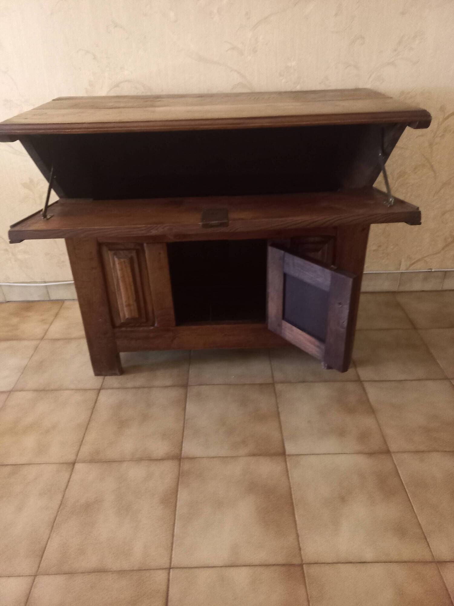 Old solid wood dough mixer carefully transformed into a bar cabinet.