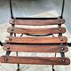 Folding garden chair with teak slats on a wrought iron structure