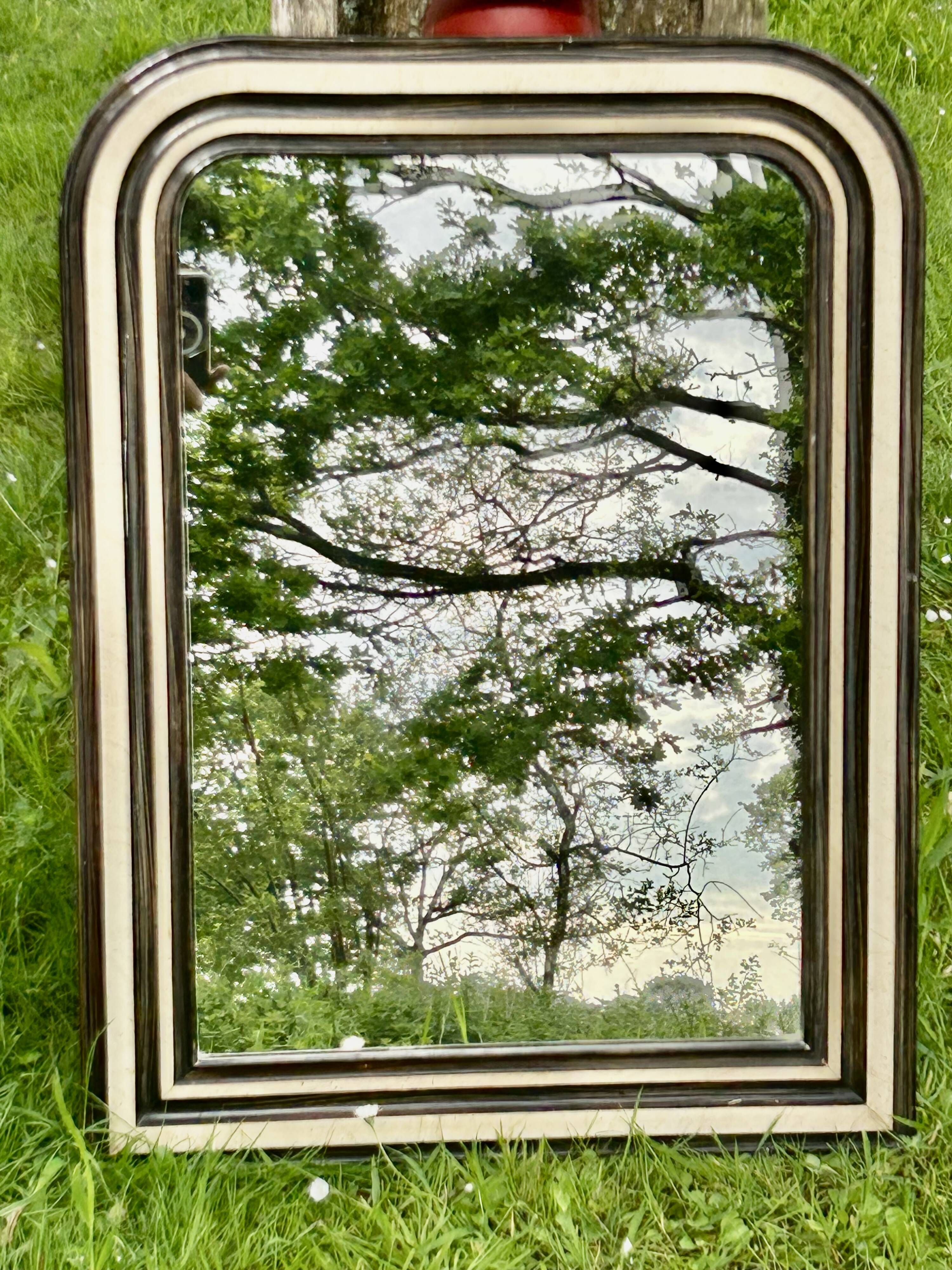 Louis Philippe mirror, wood and stucco with faux wood decoration. 19th century. 56 x 74.