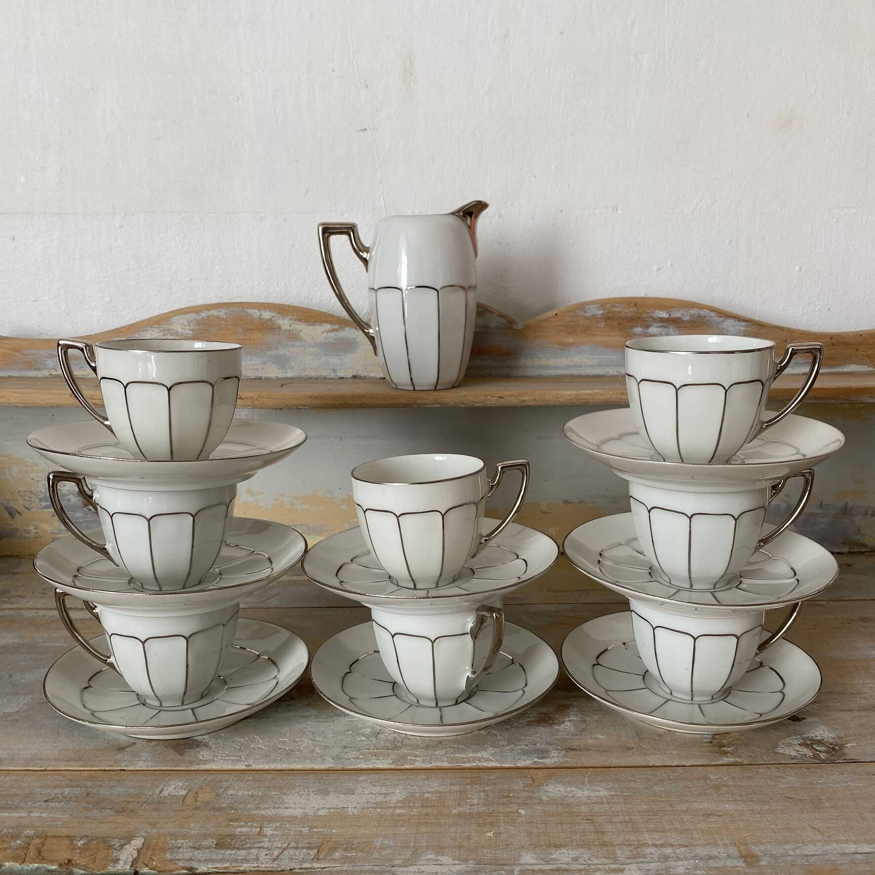 White and silver Limoges porcelain coffee cups and saucers.