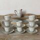 White and silver Limoges porcelain coffee cups and saucers.