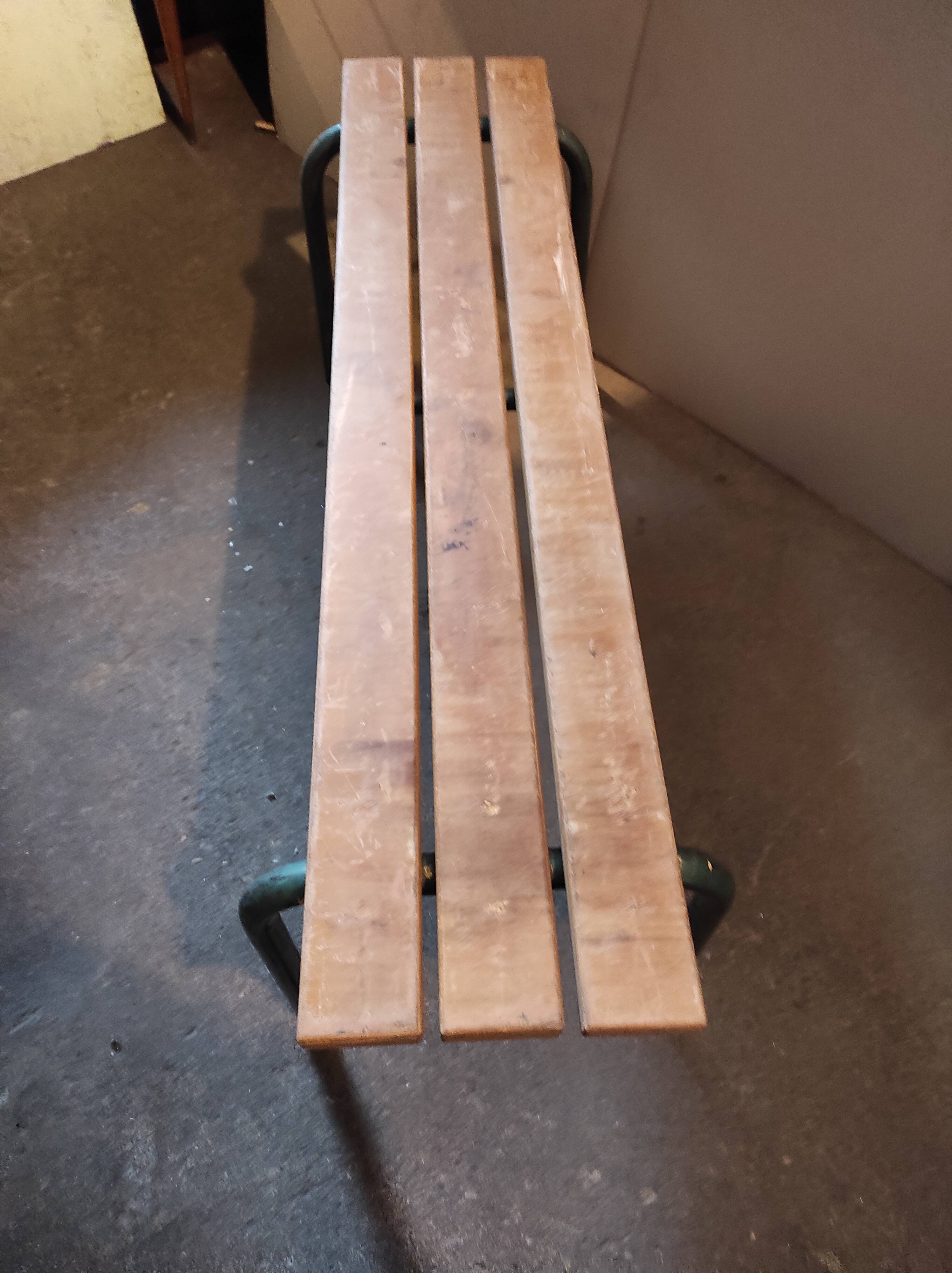 Former vintage wooden school bench and metal tubes