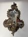 Mirror with a decorative frame featuring a four-light wall sconce, 19th century.