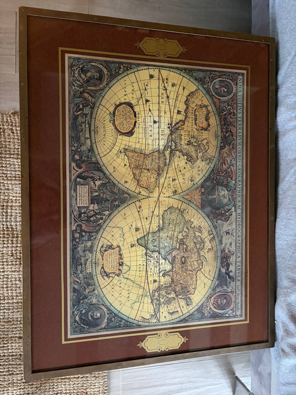 Wood and brass coffee table with a world map under glass.