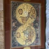 Wood and brass coffee table with a world map under glass.