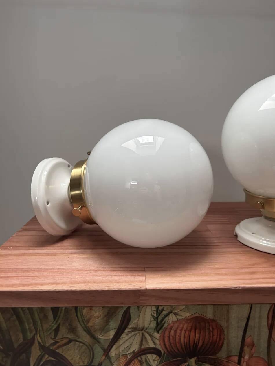 Pair of wall sconces with white opaline globes