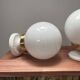 Pair of wall sconces with white opaline globes