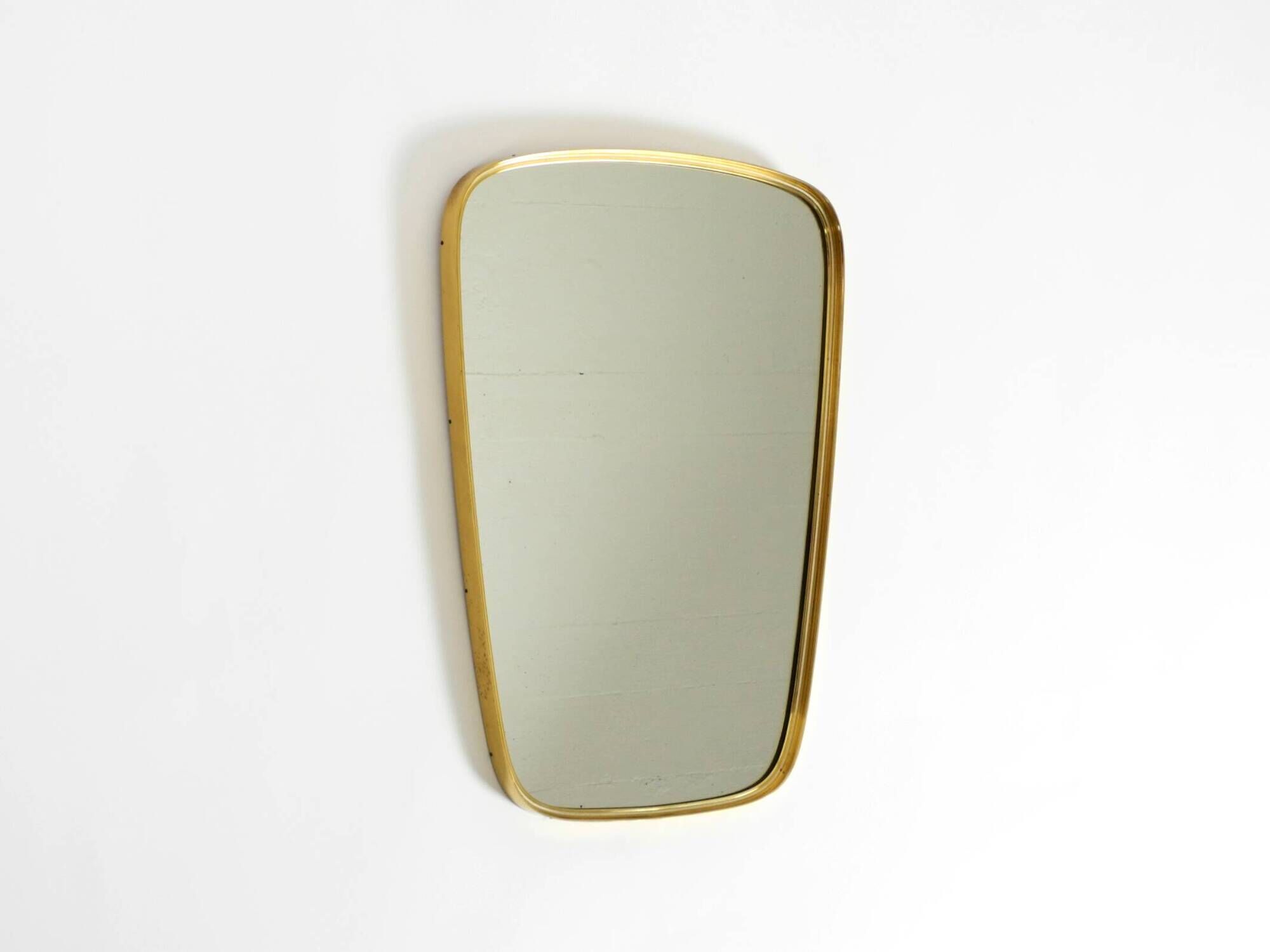 A pair of rare Mid Century "Münchener Zierspiegel" brass wall mirrors