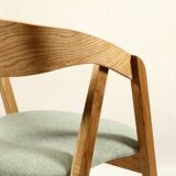 Vintage dining chair in light oak with natural linen pastel green fabric.