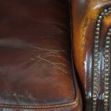 Dark English style sheepskin wingback chair with character and patina