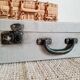 Old metal suitcase green leather handle