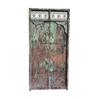 Old door of riad with forged iron pediment