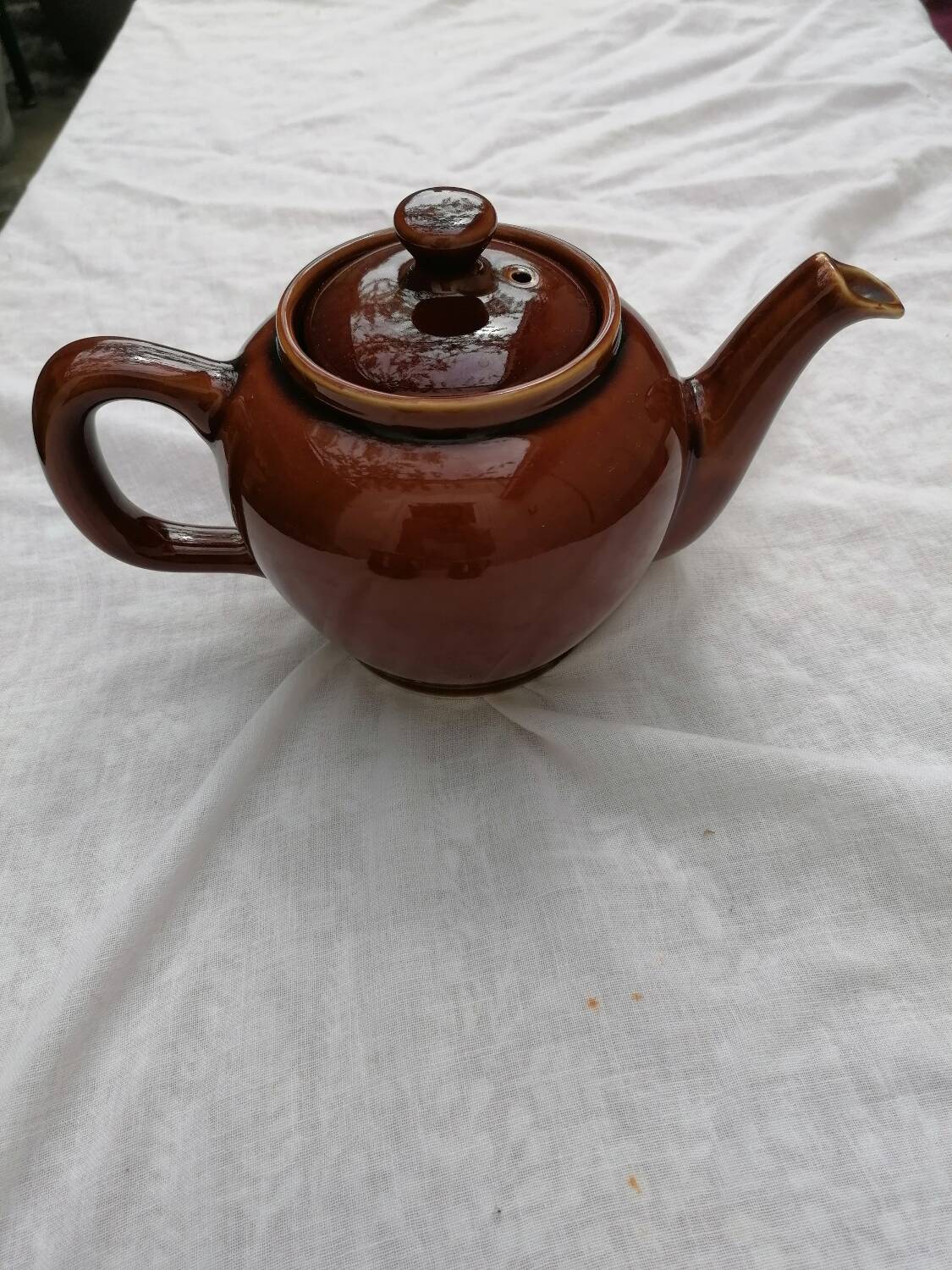 Brown ceramic teapot and milk jugs