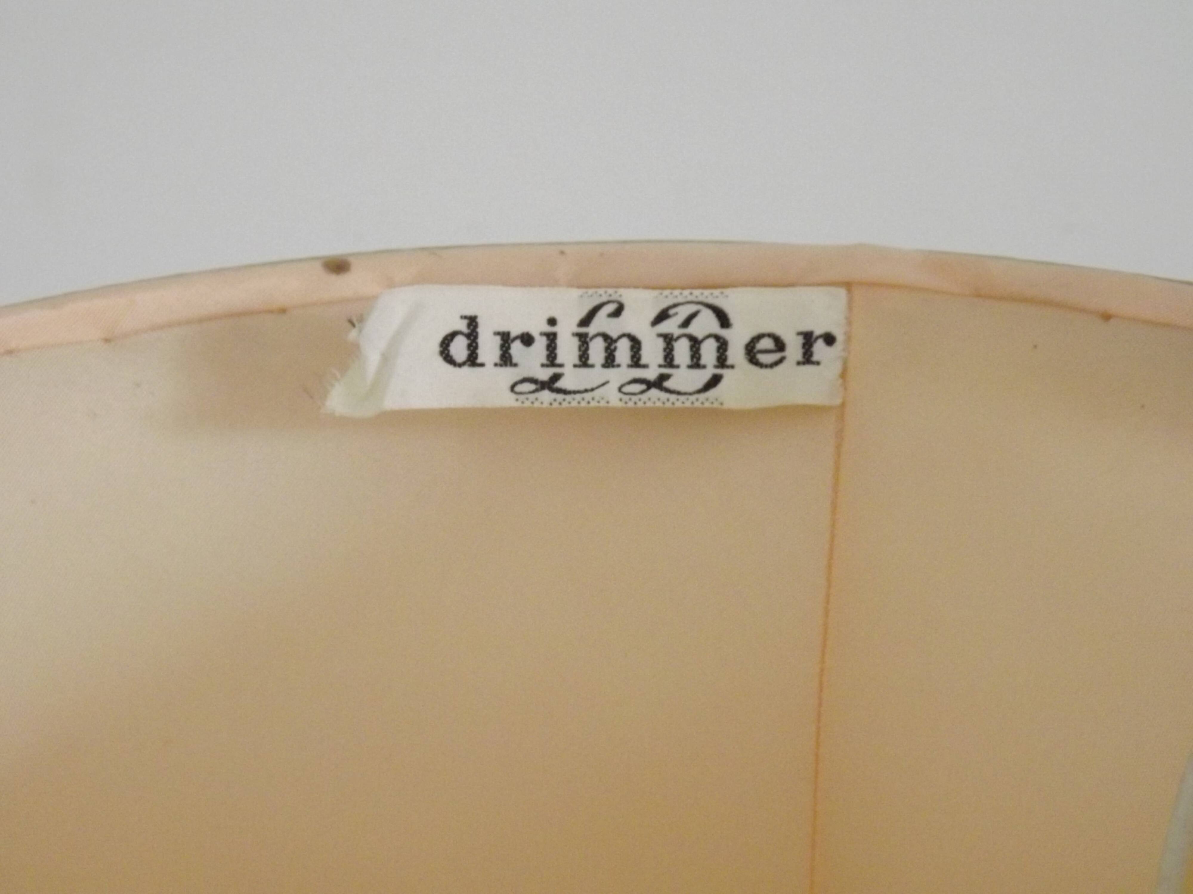 Table lamp with wooden base and fringed shade